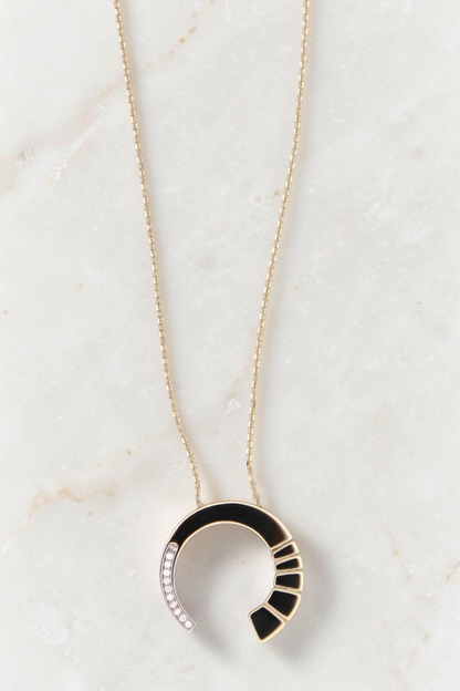 Zafrah 14k gold crescent pendant necklace featuring black enamel inlay and sparkling round CZ stones on a delicate chain