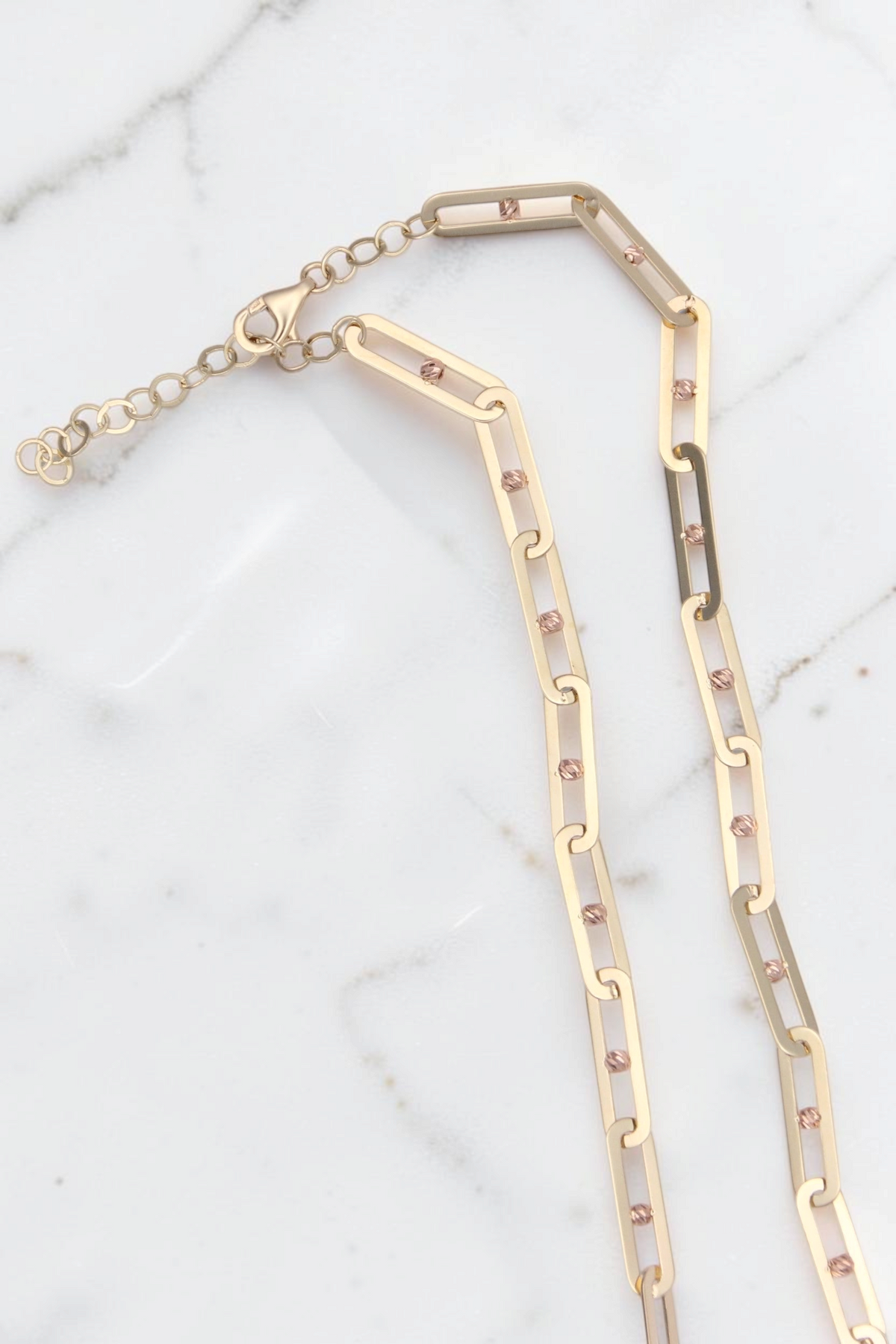 Zafrah 14k solid gold paperclip link Y necklace with adjustable chain and delicate textured bead accents.