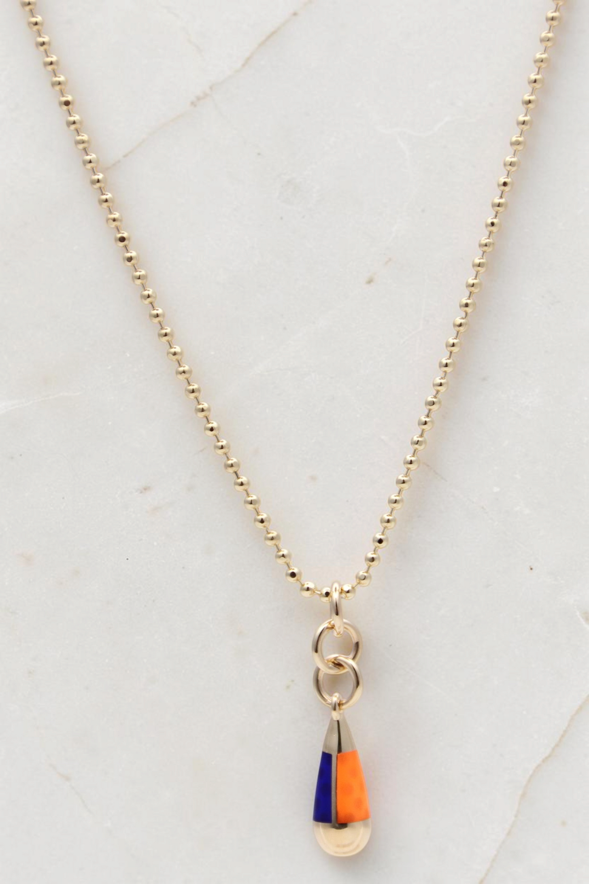 Zafrah 14k gold beaded chain necklace featuring an orange and blue drop pendant on a delicate gold link