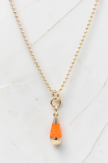 Zafrah 14k solid gold beaded chain necklace featuring an orange and blue drop pendant on a white marble background