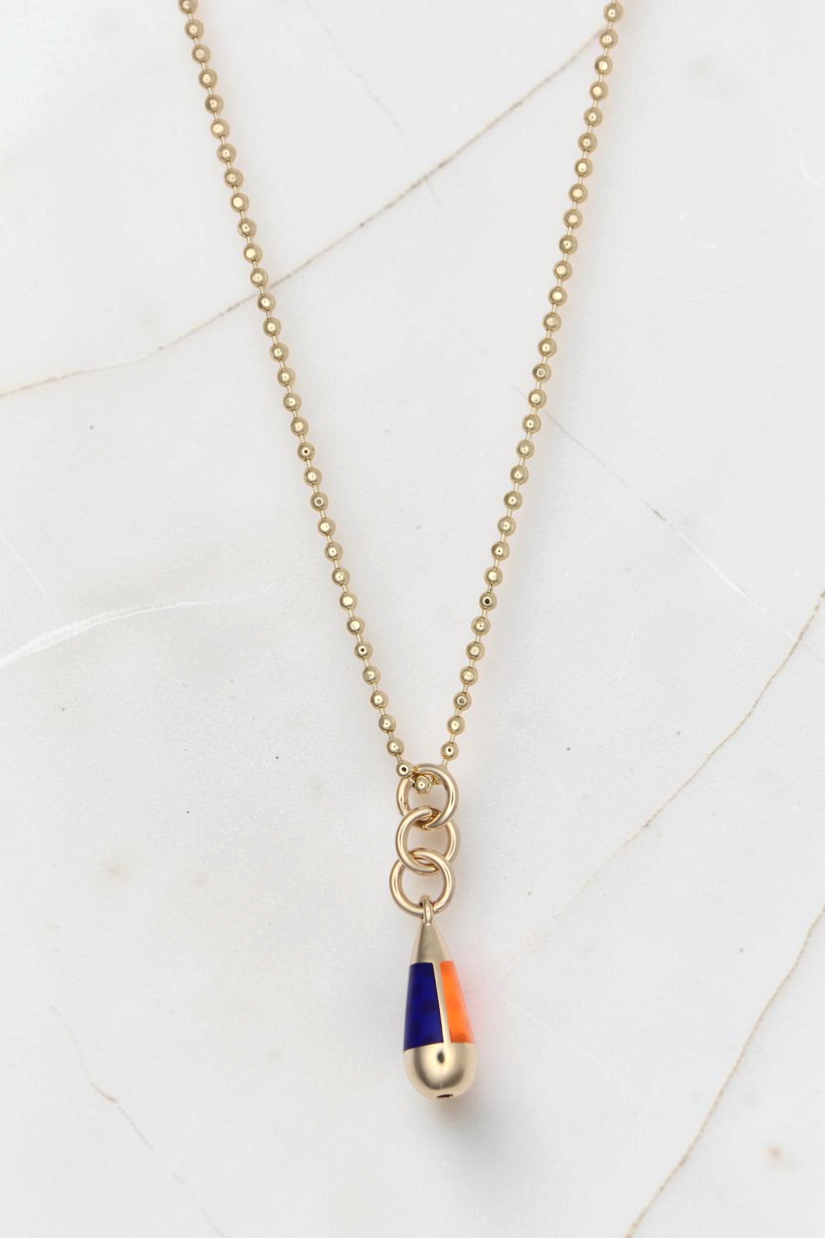 Zafrah 14k gold bead chain necklace featuring a drop pendant with blue and orange enamel accents