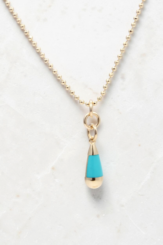 Zafrah 14k gold beaded chain necklace featuring a turquoise and white teardrop pendant on a light background.