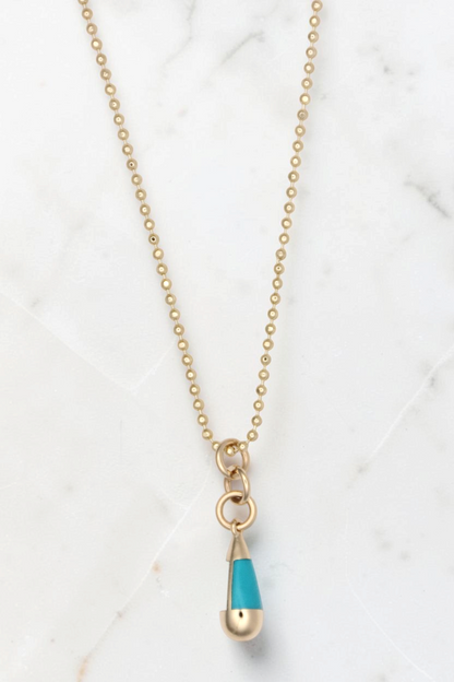 Zafrah 14k gold beaded chain necklace featuring a turquoise and gold drop pendant on a white background