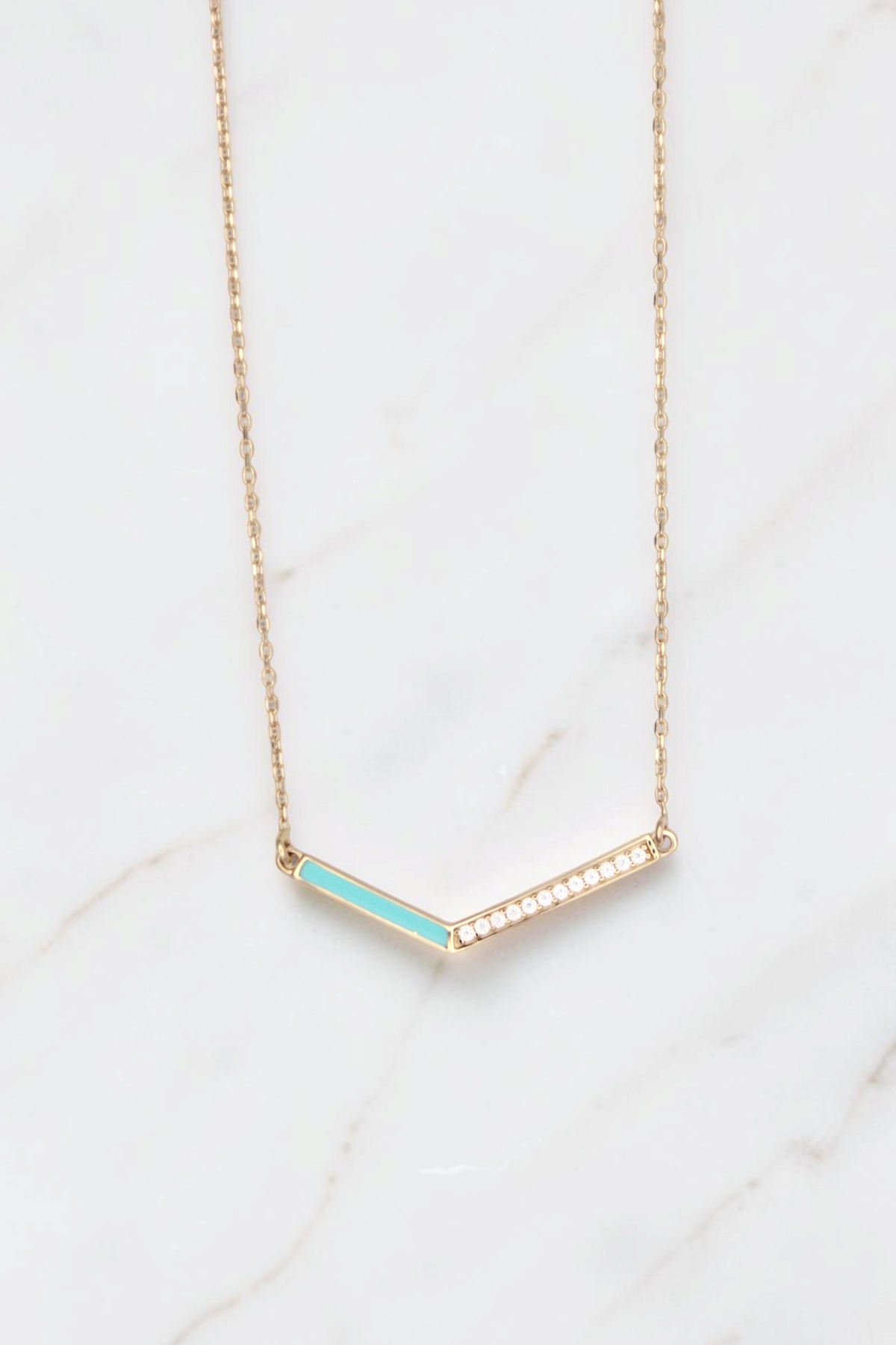 Zafrah 14k gold V-shaped pendant necklace featuring a turquoise enamel inlay and a row of sparkling white diamonds.