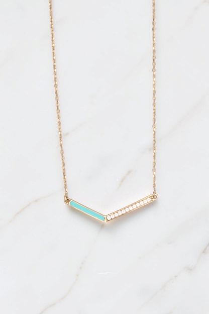 Zafrah 14k gold V-shaped pendant necklace featuring a turquoise enamel inlay and a row of sparkling white diamonds.