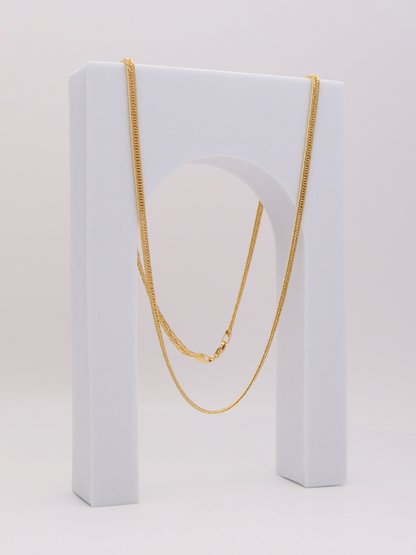 Zafrah 14k yellow gold 2.75mm snake chain necklace, 21.5 inches long, displayed on a white arch stand.
