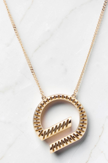 Zafrah 14k solid gold G shaped pendant necklace on a delicate curb chain, 18 inches long with textured detailing.