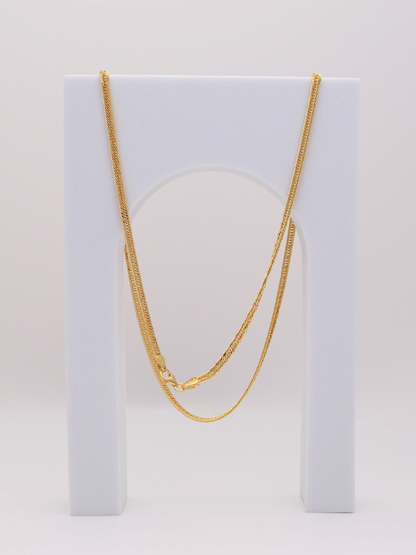 Zafrah 14k yellow gold 2.75mm snake chain necklace, 21.5 inches long, displayed on a white arch stand.