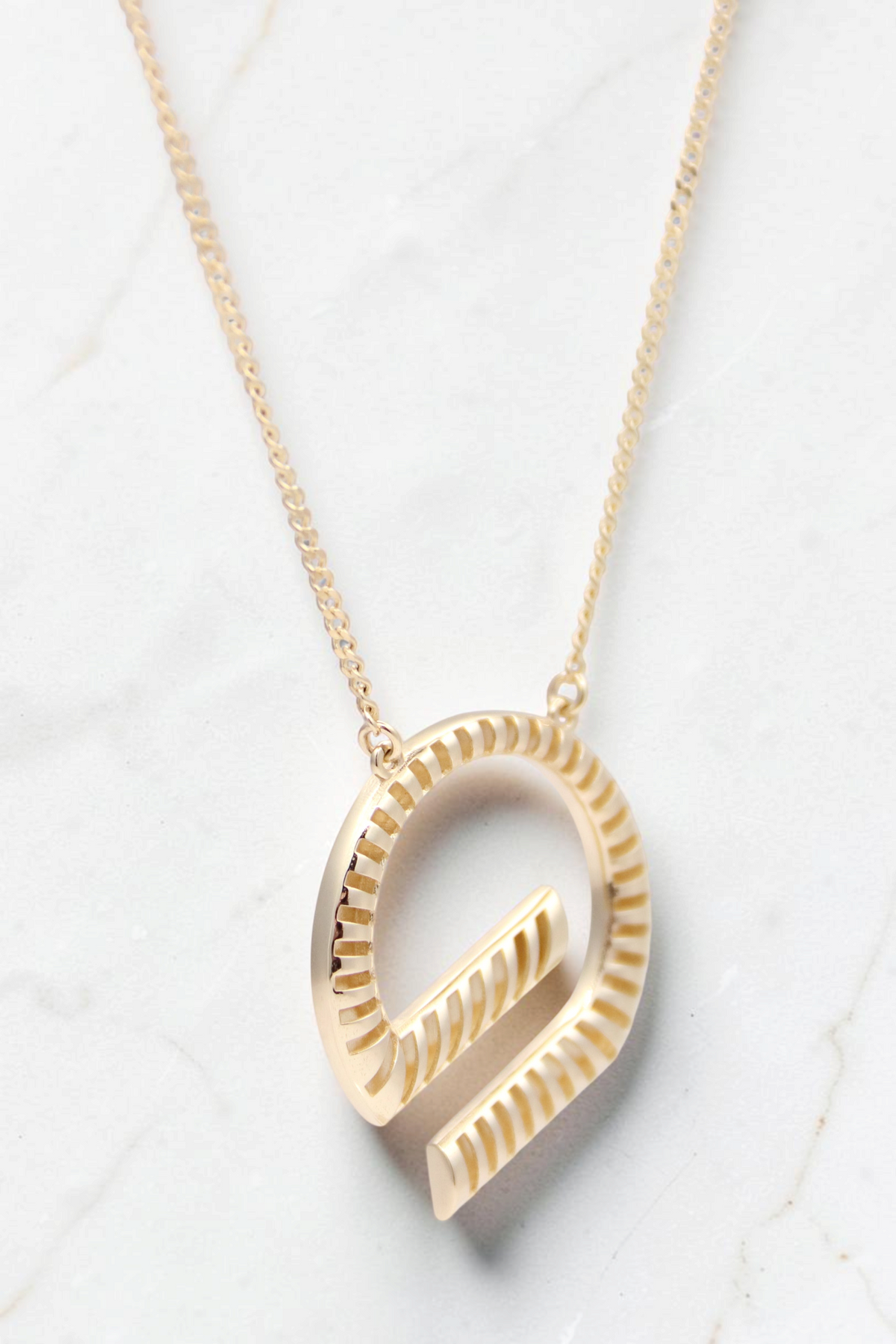Zafrah 14k solid gold G shaped pendant necklace with a textured curb chain, 18 inches long.