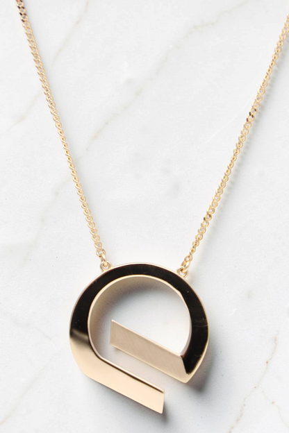 Zafrah 14k solid gold G shaped pendant necklace on an 18 inch curb chain with a polished finish