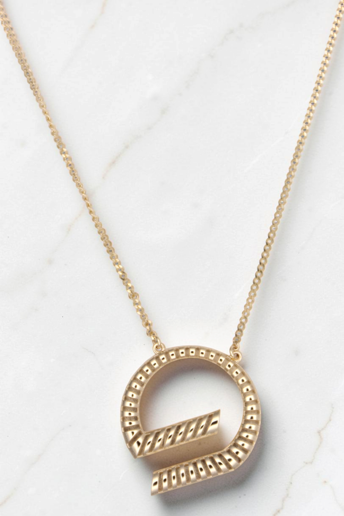 Zafrah 14k solid gold G-shaped pendant necklace on an 18-inch curb chain with a textured, ribbed design.