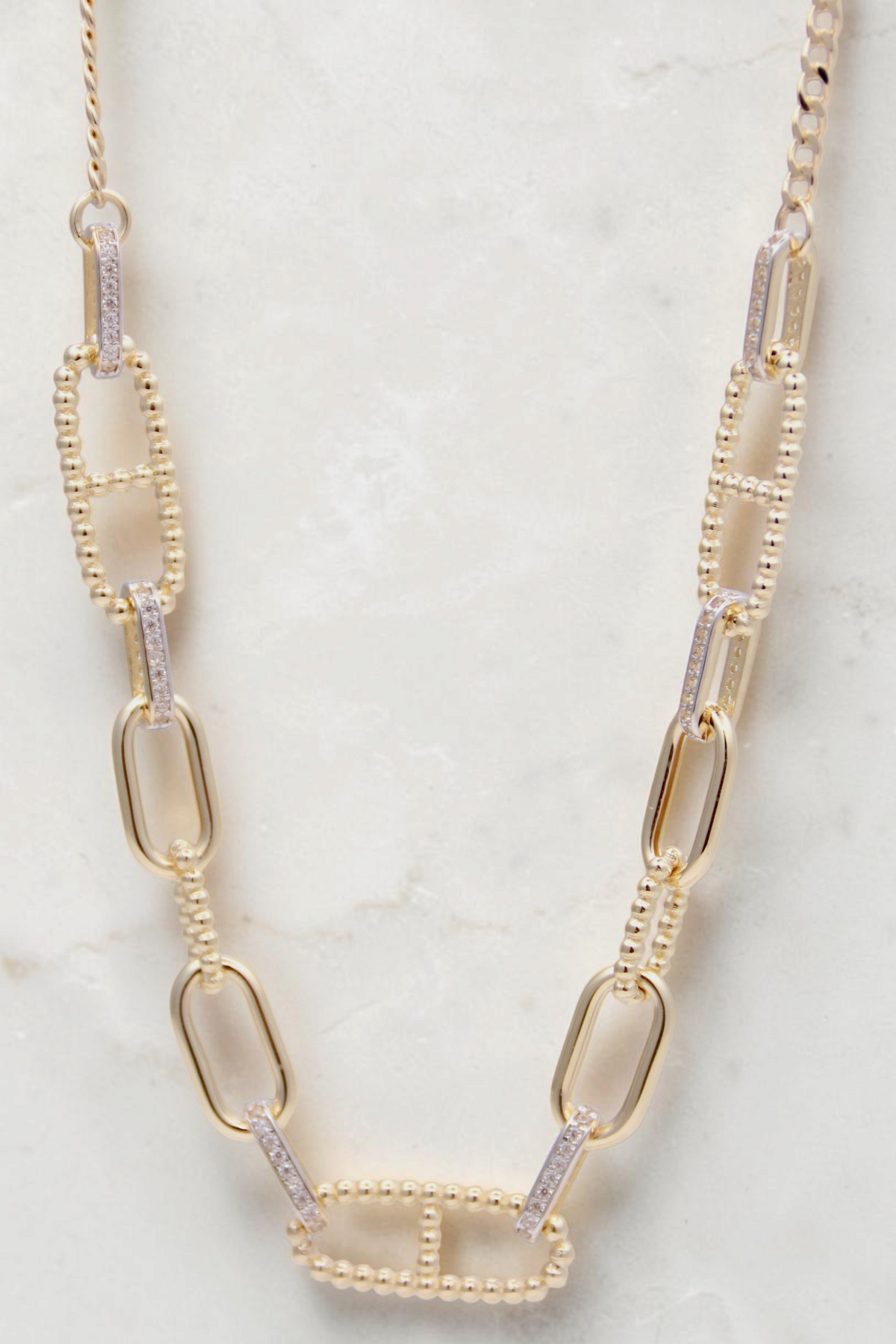 Zafrah 14k solid gold necklace featuring alternating paperclip and diamond-accented oval links, 18 inches long.
