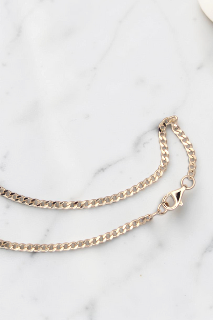 Zafrah 14k solid gold chain necklace featuring a delicate link design with a secure lobster clasp closure.