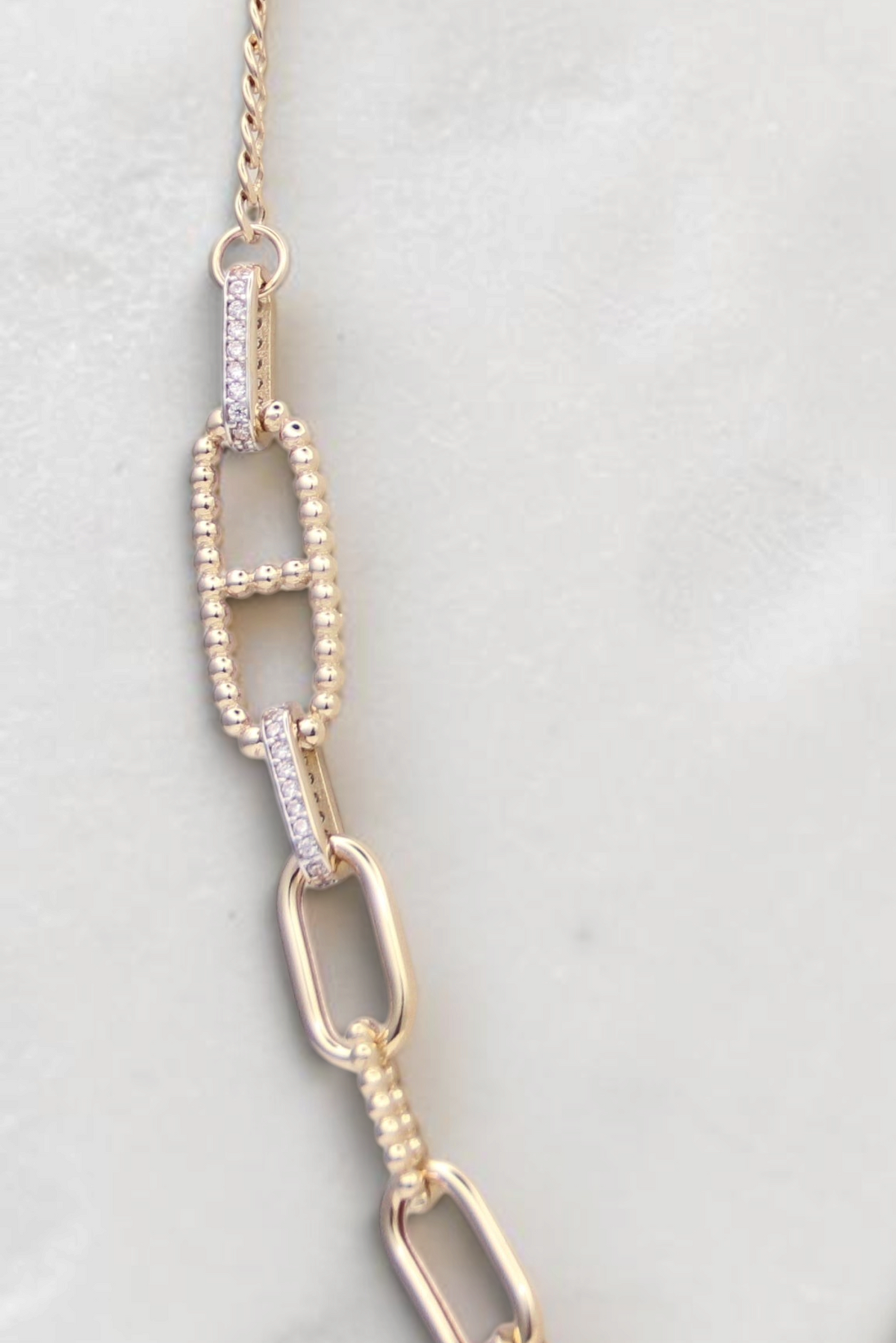 Zafrah 14k solid gold necklace featuring alternating paperclip and oval links with delicate diamond accents.