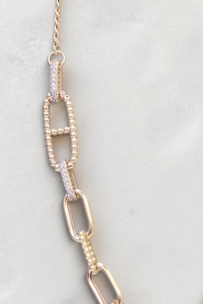 Zafrah 14k solid gold necklace featuring alternating paperclip and oval links with delicate diamond accents.