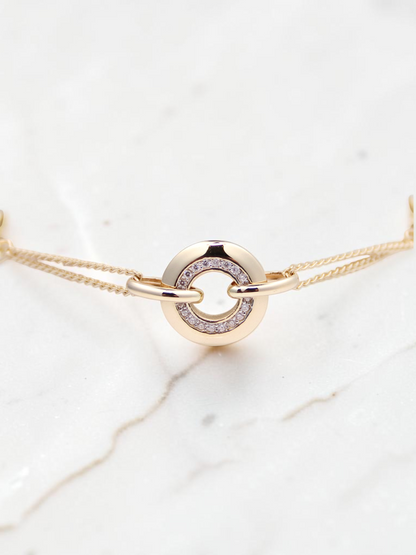 Zafrah 14k solid gold curb chain bracelet featuring a central round link with sparkling CZ stones on a white display