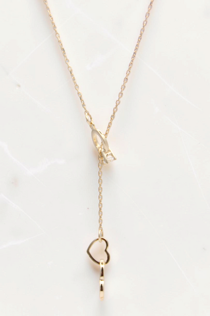 Zafrah 14k solid gold double heart drop pendant necklace on an 18-inch cable chain with a delicate lariat design.
