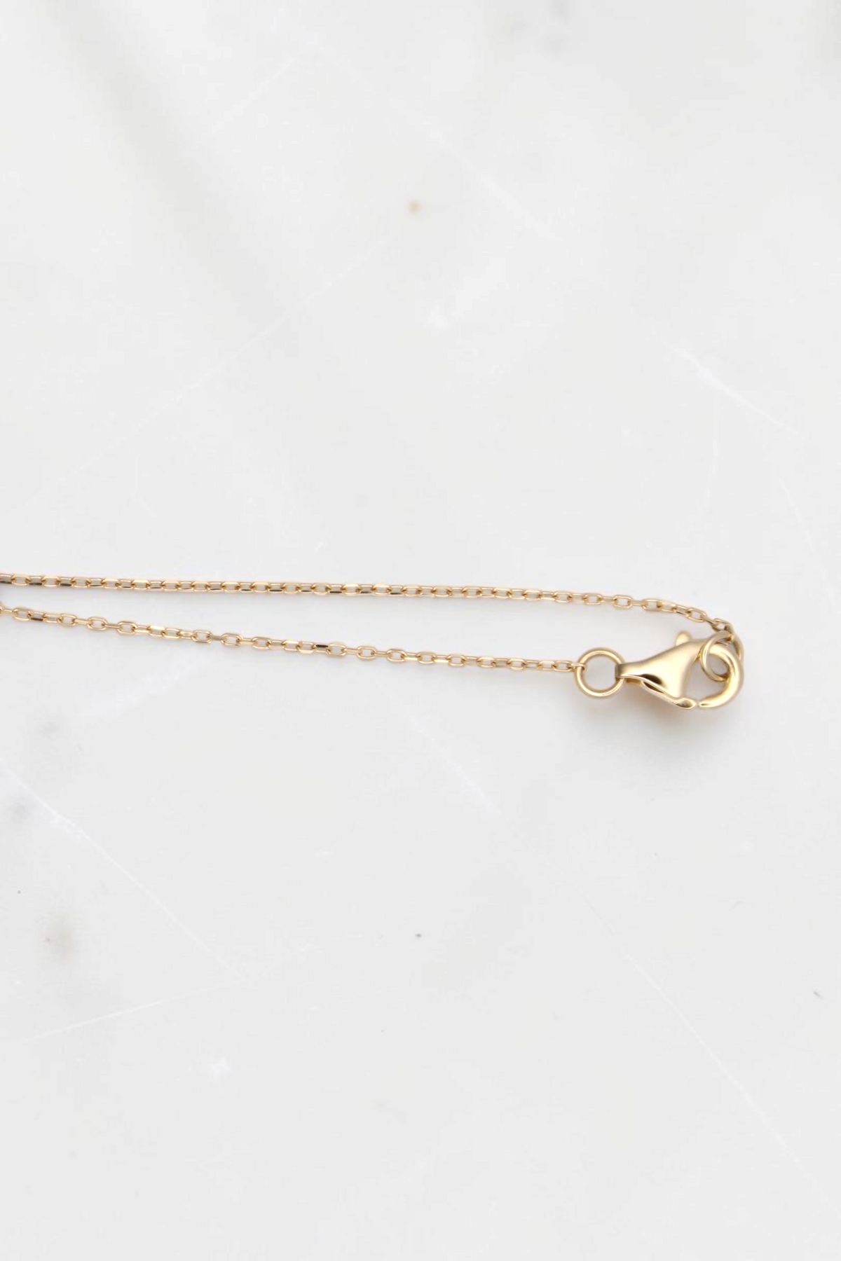 Zafrah 14k solid gold cable chain necklace with a lobster clasp closure, 18 inches long.