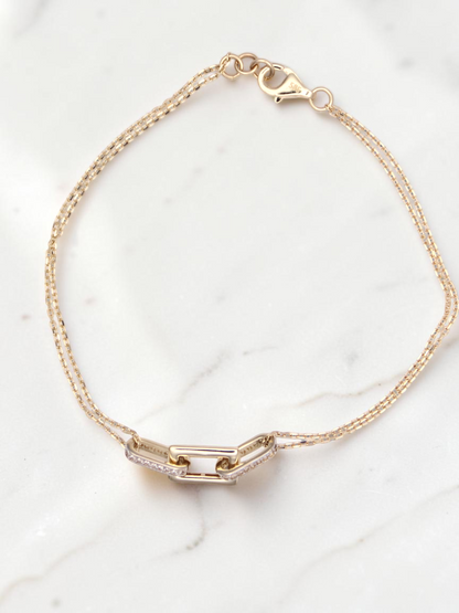Zafrah 14k solid gold double cable chain bracelet featuring a central rectangle and oval link with diamond accents.