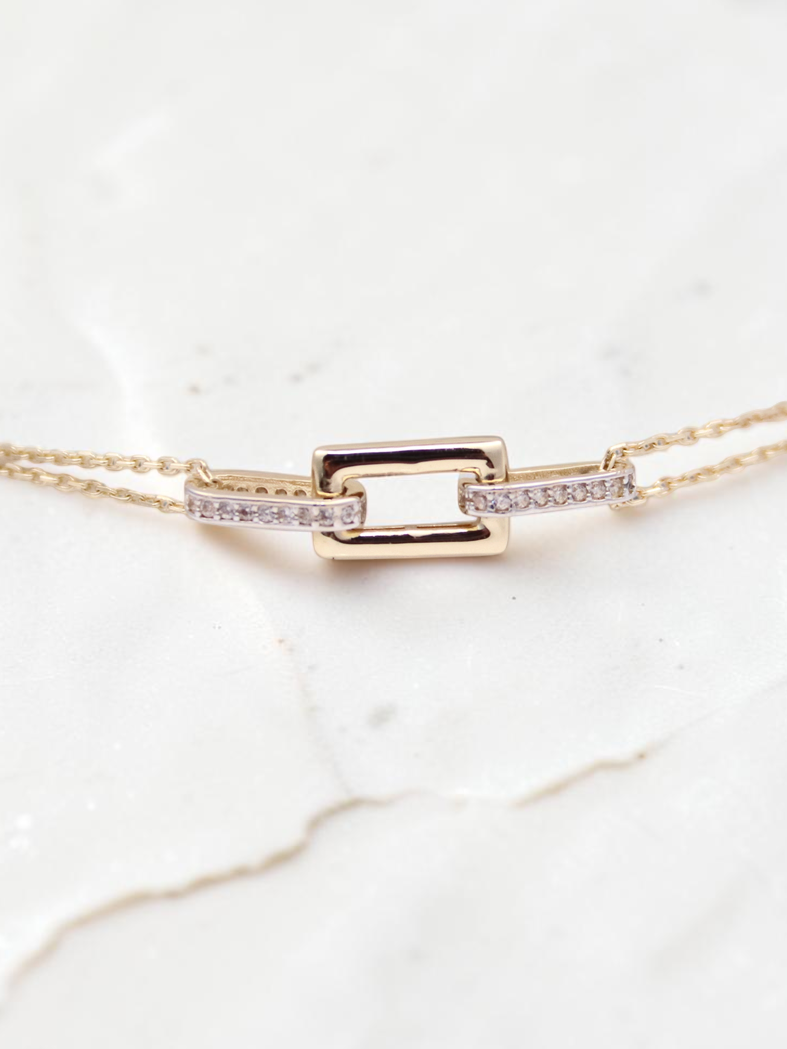 Zafrah 14k solid gold double cable bracelet featuring a central rectangle and oval link design with diamond accents.