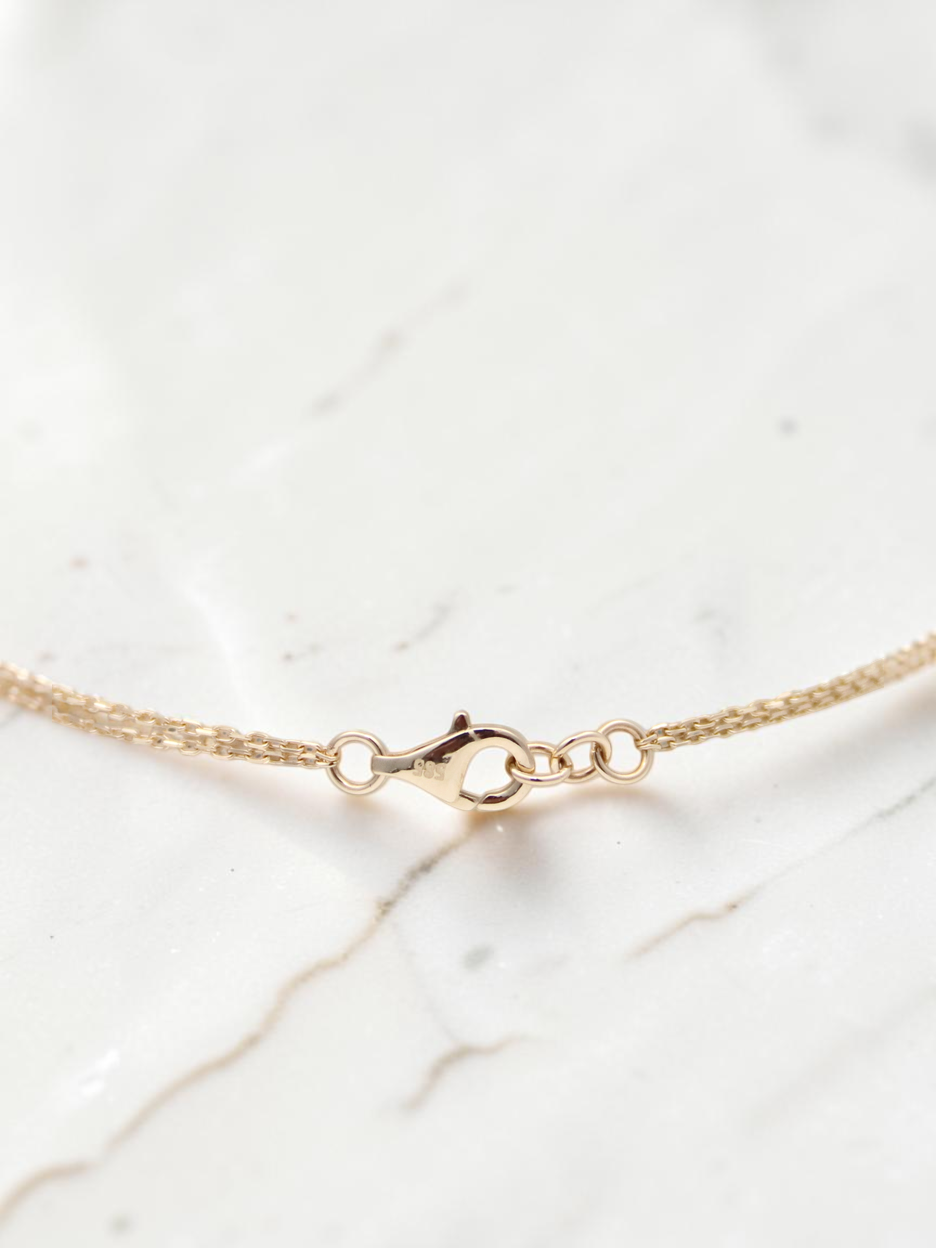 Zafrah 14k solid gold double cable bracelet featuring a secure lobster clasp and rectangle and oval link design.