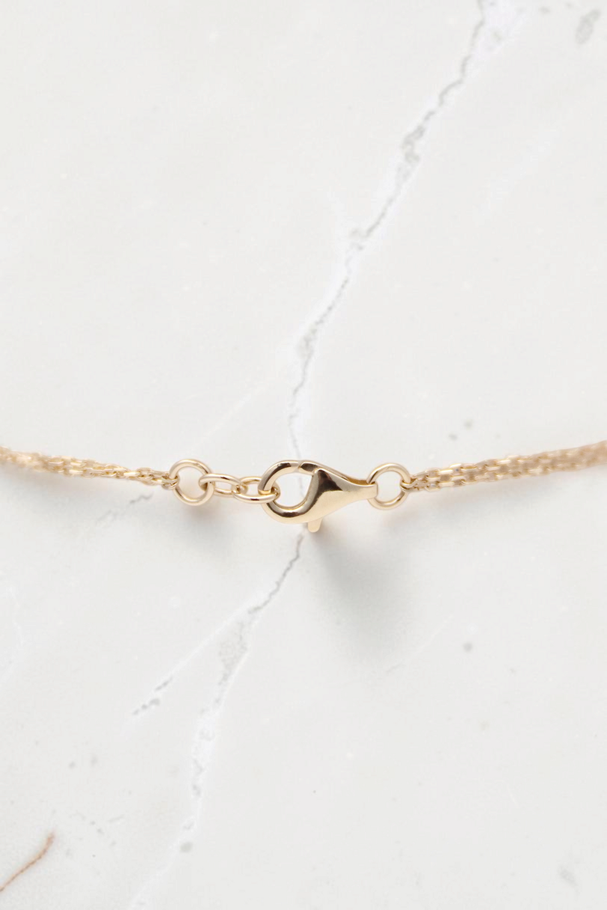 Zafrah 14k solid gold double cable bracelet featuring a delicate round link chain and secure lobster clasp closure.