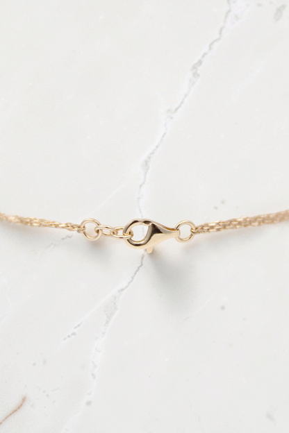 Zafrah 14k solid gold double cable bracelet featuring a delicate round link chain and secure lobster clasp closure.