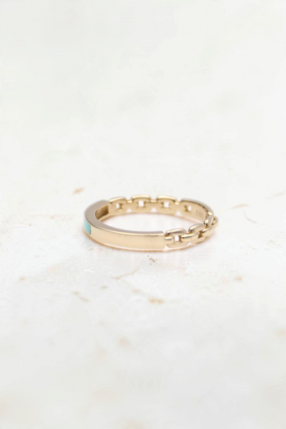 Zafrah 14k solid gold chain link ring with a smooth band section and a small turquoise accent on a white background.