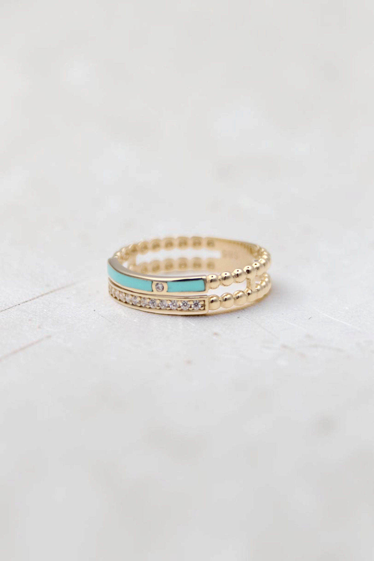 Zafrah 14k solid gold double beaded band ring featuring a turquoise enamel inlay and round clear stones.