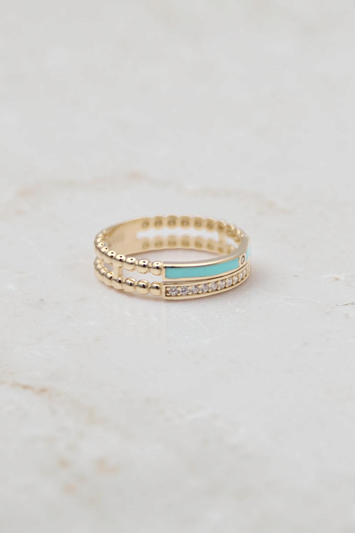 Zafrah 14k solid gold double beaded band ring featuring a turquoise enamel inlay and a row of clear round stones.