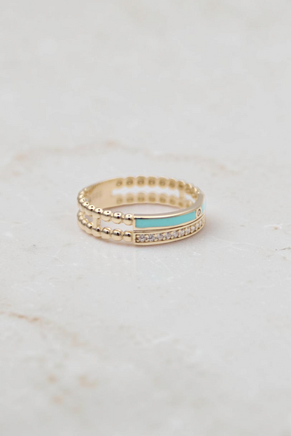 Zafrah 14k solid gold double beaded band ring featuring a turquoise enamel inlay and a row of clear round stones.