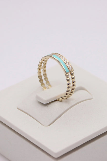 Zafrah 14k solid gold double beaded band ring featuring a central turquoise enamel inlay and clear round stones.