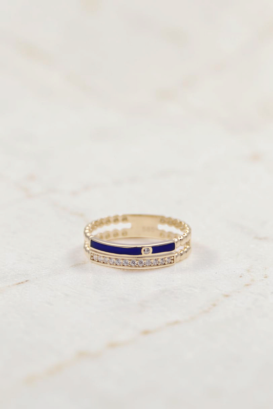 Zafrah 14k gold double band ring featuring a blue enamel stripe, clear stones, and beaded edges on a white background.