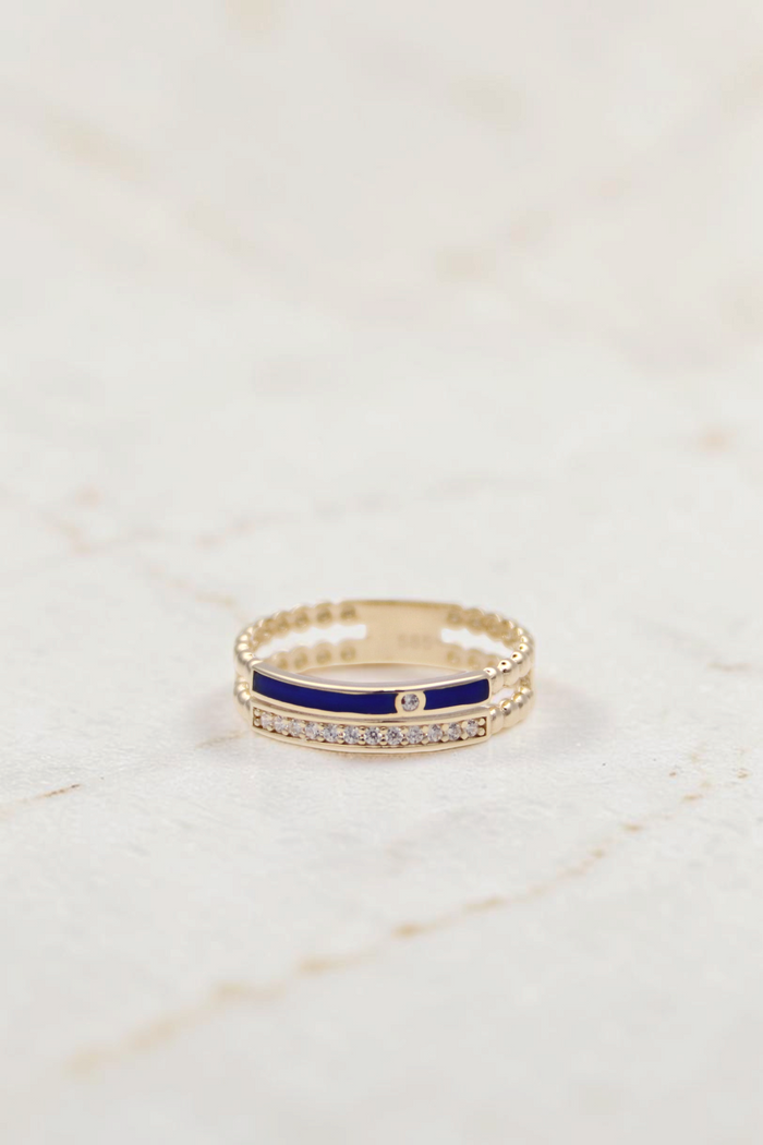 Zafrah 14k gold double band ring featuring a blue enamel stripe, clear stones, and beaded edges on a white background.