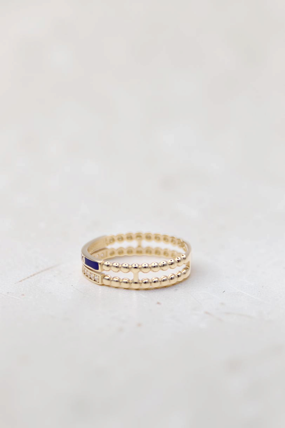 Zafrah 14k solid gold double beaded ring featuring round clear stones and a blue enamel accent, size 7.