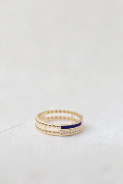 Zafrah 14k solid gold double beaded ring featuring a blue enamel stripe and a row of round clear stones