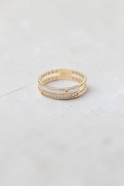 Zafrah 14k solid gold double beaded band ring featuring a clear stone and white inlay on a white background