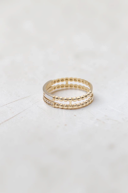 Zafrah 14k solid gold double beaded band ring featuring round clear stones and a smooth white inlay detail.