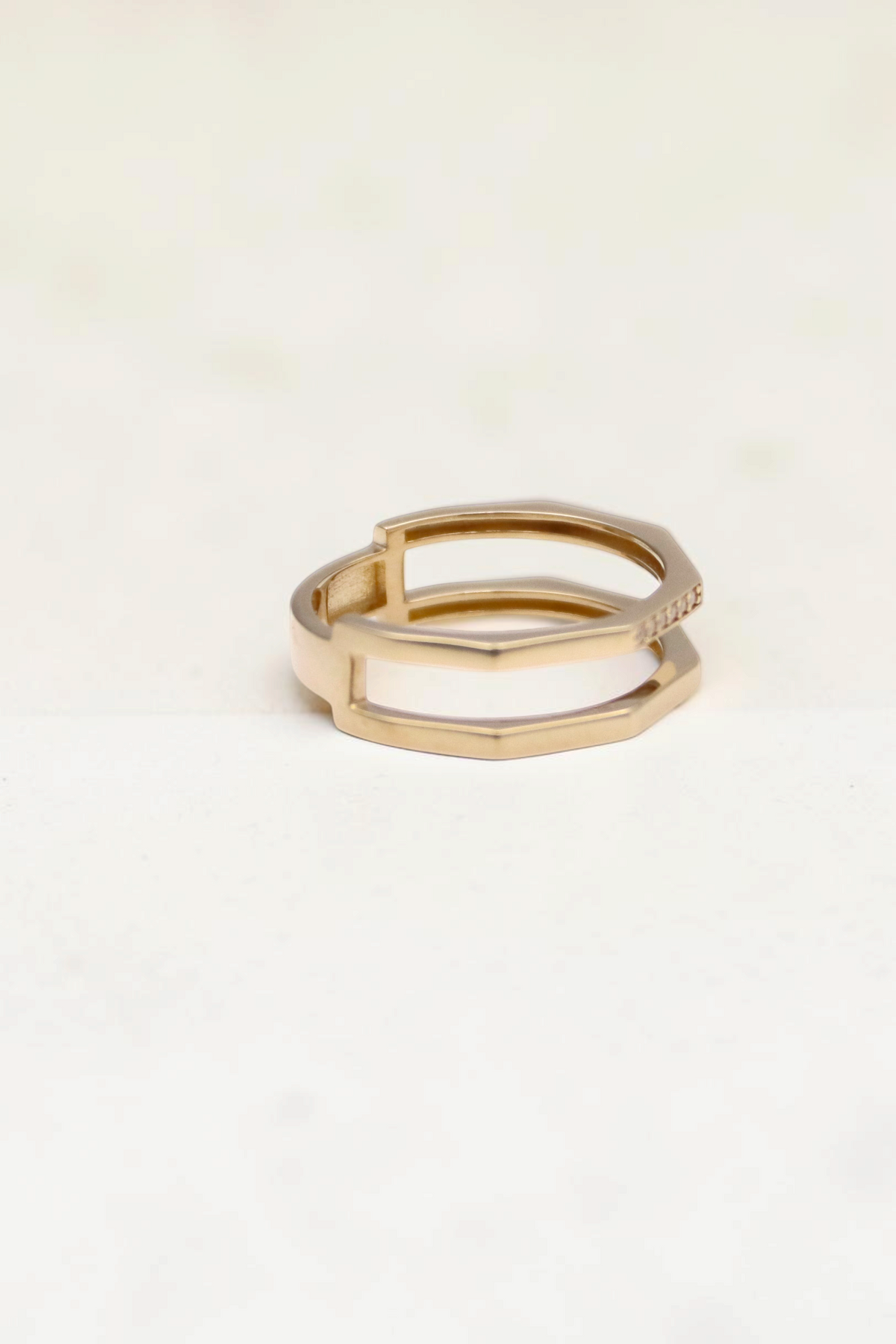 Zafrah double geometric band ring in solid 14k yellow gold with flat edges on a white background