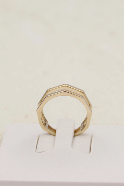 Zafrah double geometric band ring in solid 14k yellow gold with flat edges on a white display stand