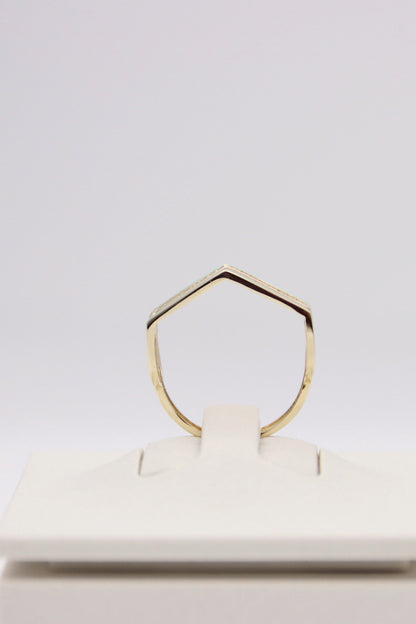 Zafrah 14k solid gold triple line ring with a pointed geometric design on a white display stand.
