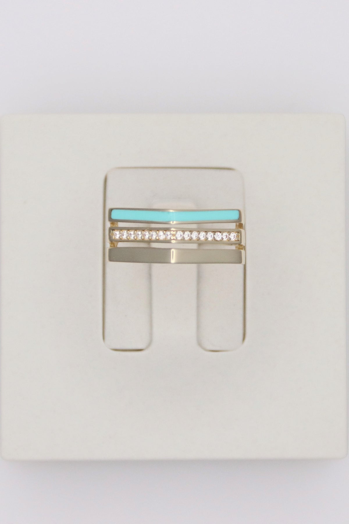 Zafrah 14k solid gold triple line ring featuring a turquoise enamel band, a diamond-set band, and a plain gold band.