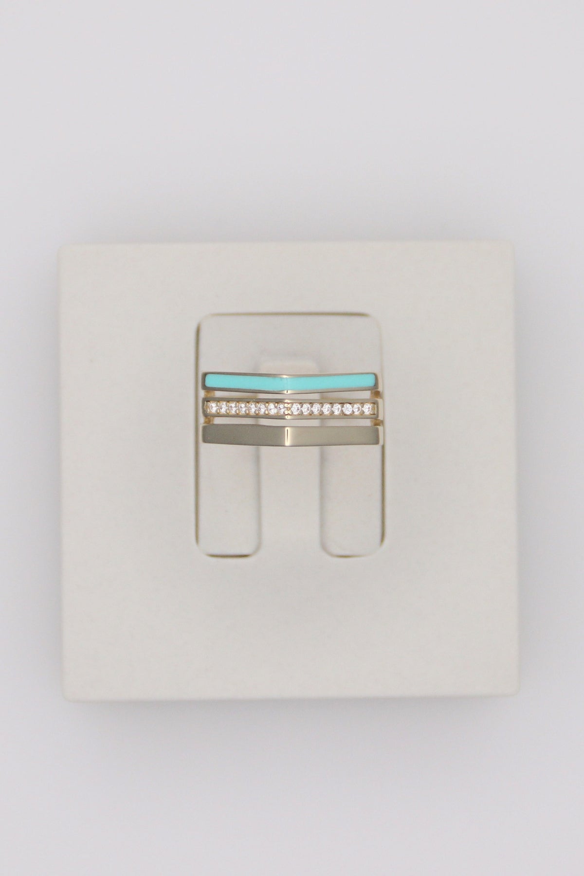 Zafrah triple line ring in 14k solid gold featuring a turquoise enamel band and a row of sparkling diamonds