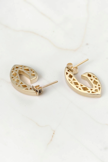 Zafrah 14k solid gold geometric triangle earrings with intricate cutout patterns on a white background