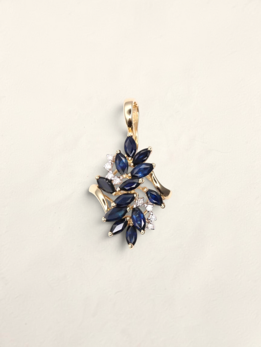 Zafrah 14k yellow gold pendant featuring marquise-cut blue sapphires and round diamond accents in a floral cluster.