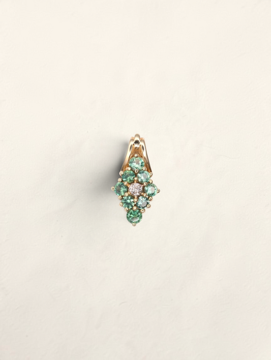 Zafrah 14K yellow gold pendant featuring round greenish-blue topaz stones and a central diamond in a cluster design.