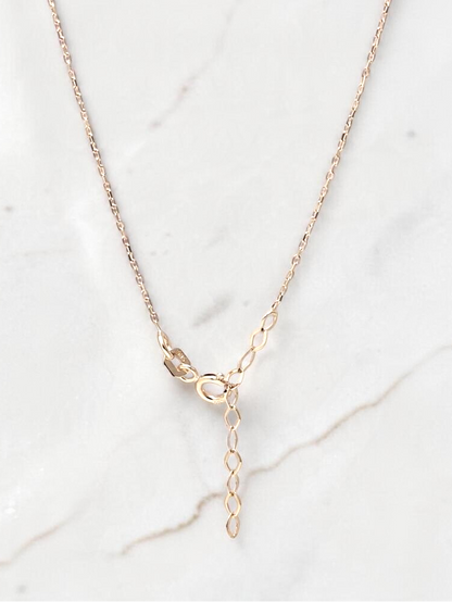 Zafrah 14k yellow gold beaded paperclip necklace with adjustable clasp detail on a white marble background