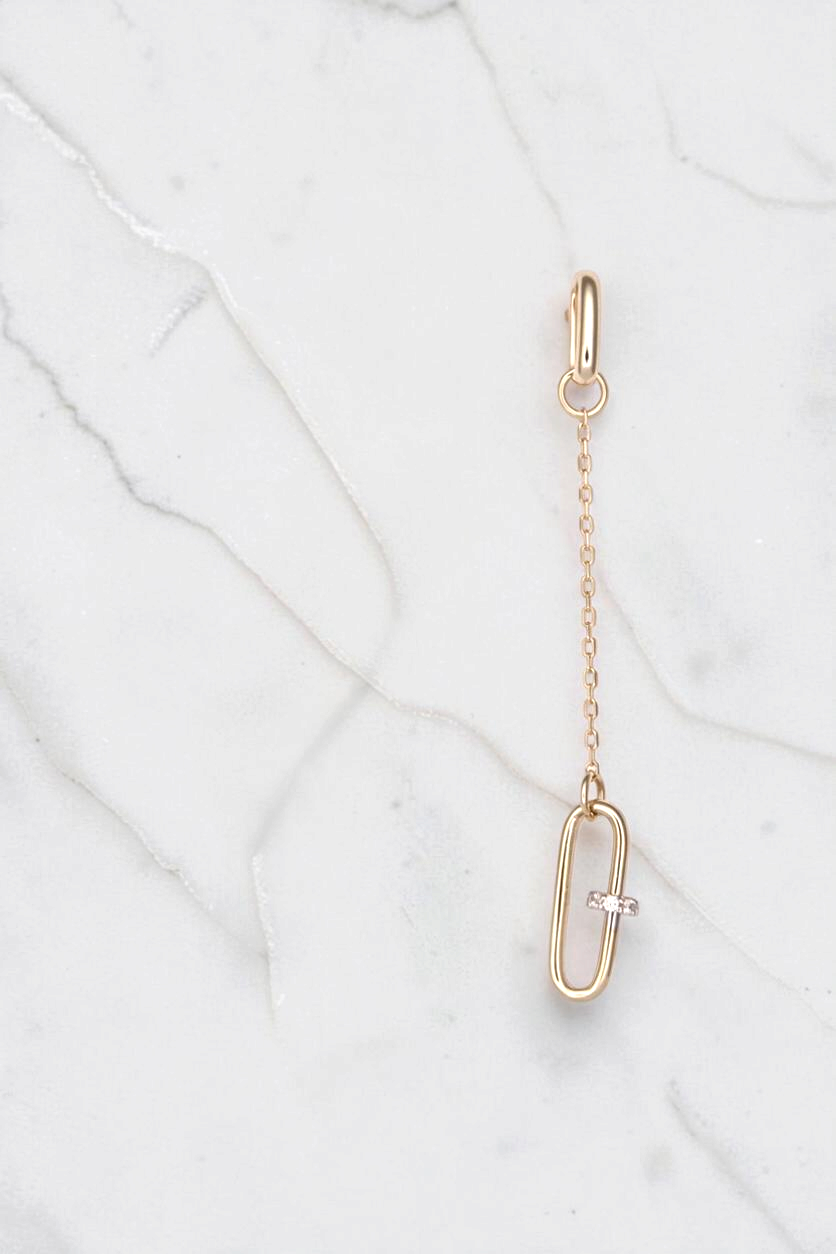 Zafrah 14k solid gold paperclip drop earrings featuring a delicate chain and a single diamond-accented link.
