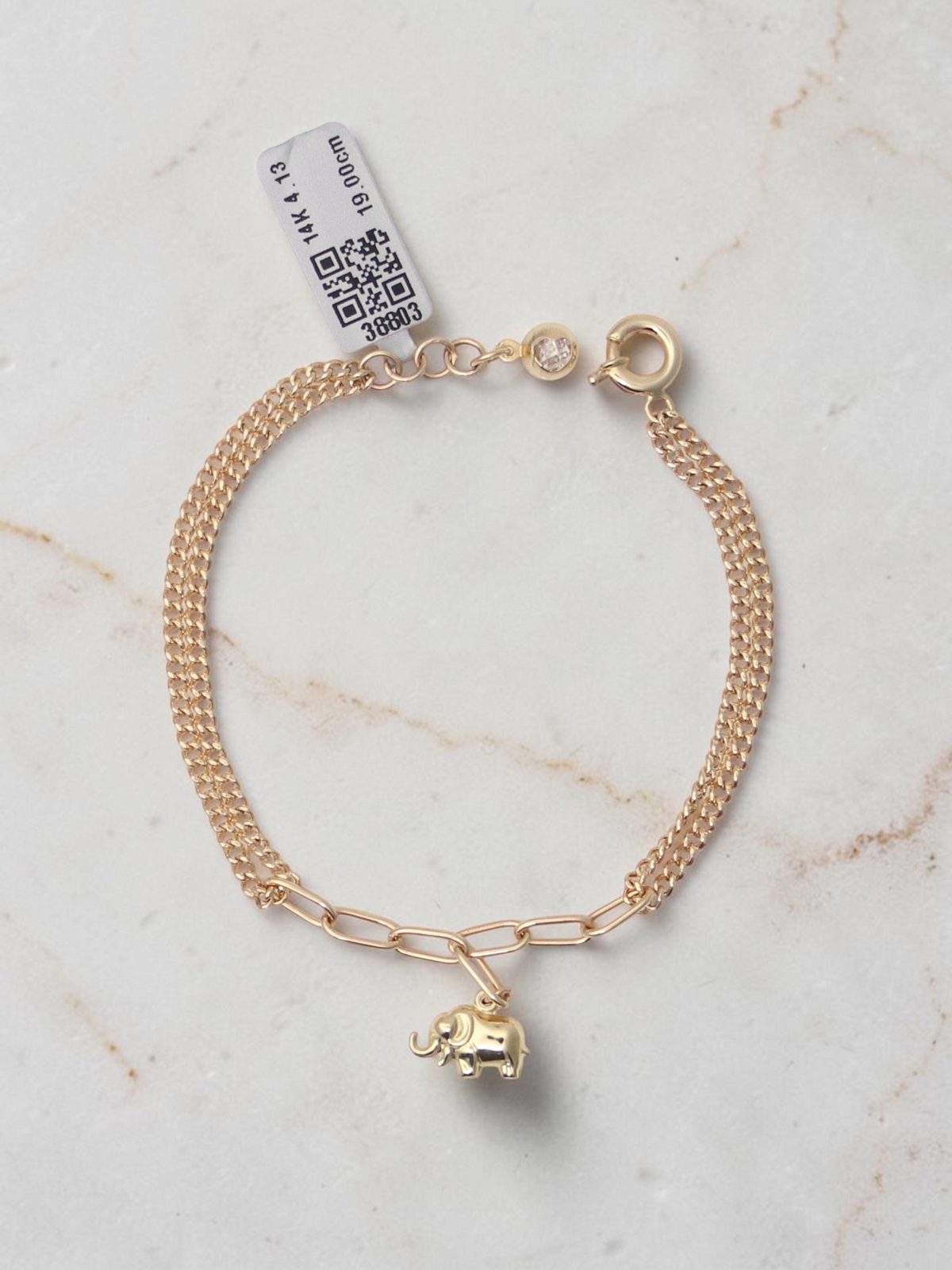 Zafrah 14k yellow gold bracelet featuring an elephant charm on a mixed paperclip and double curb link chain