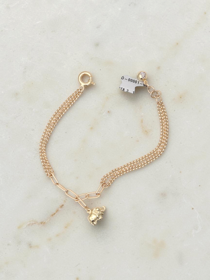 Zafrah 14k yellow gold bracelet featuring an elephant charm on a mixed paperclip and double curb link chain.